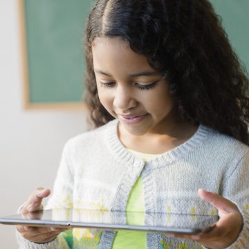 Mixed race student using digital tablet in classroom Movistar crea “Centro de transparencia y privacidad” para que clientes puedan cuidar sus datos personales